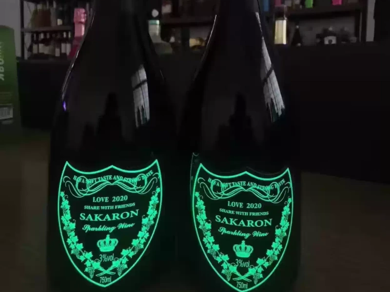 Custom glow-in-the-dark decorative labels applied to dark glass bottles