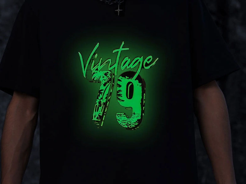 Custom glow-in-the-dark DTF heat transfer printed on a black T-shirt